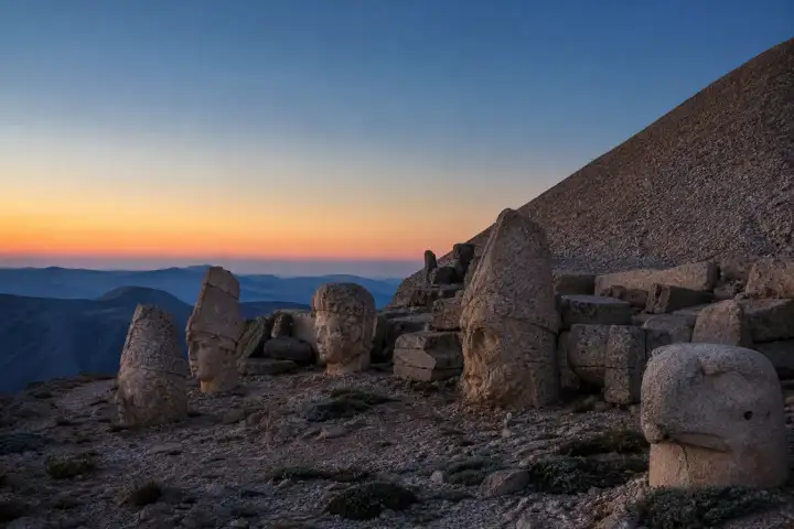 Weathered Commagene stone heads on the western terrace of Mount Nemrut before sunrise.