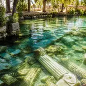 Ancient marble columns beneath the clear thermal water of the Hierapolis Antique Pool near Pamukkale.