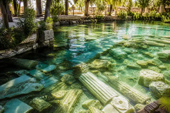 Ancient marble columns beneath the clear thermal water of the Hierapolis Antique Pool near Pamukkale.