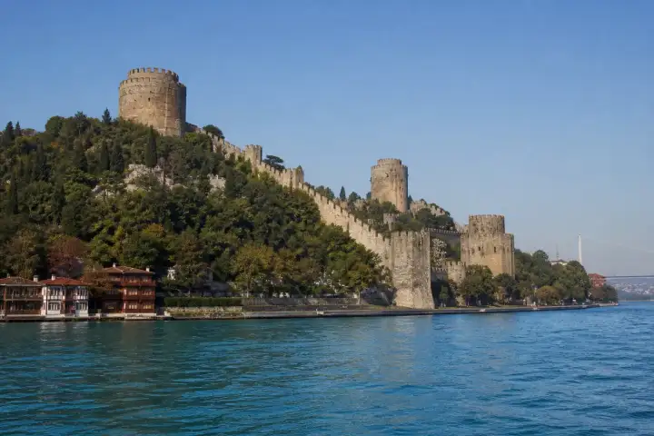 The stone towers and walls of Rumeli Fortress rising above the Bosphorus in Istanbul.
