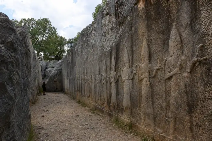 A weathered procession of Hittite deity reliefs carved into the rock sanctuary of Yazılıkaya.