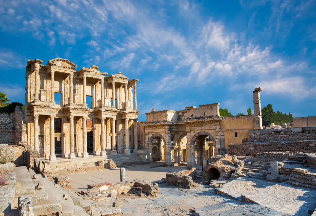 Morning light warms the Library of Celsus and the triple gate beside it at Ephesus, the marble forecourt almost empty.