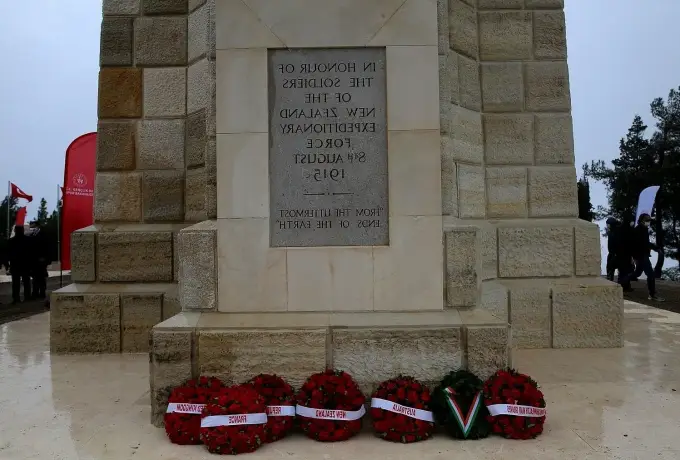 Poppy wreaths are laid at the foot of an inscribed stone memorial to New Zealand forces on the Gallipoli peninsula.