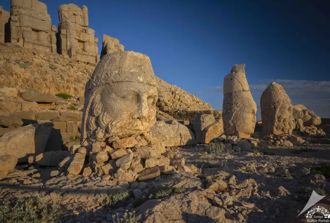 Raking morning light picks out the curly beard and crown of a stone head on the east terrace of Mount Nemrut.
