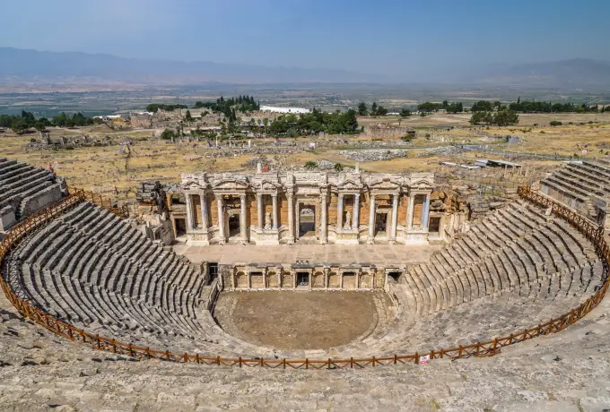 From the upper seats of the Hierapolis theatre, the carved two-storey stage building stands above the empty orchestra.