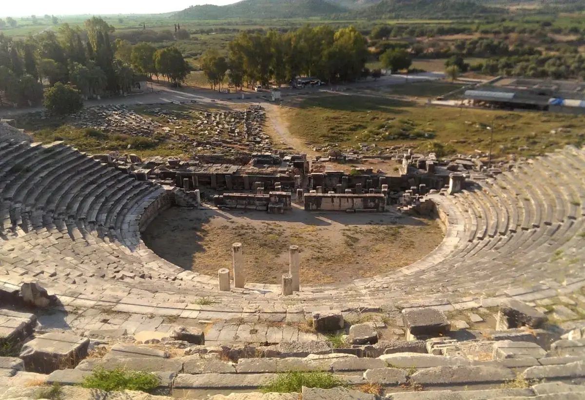 The great curved theatre of Miletus opens onto the flat green plain that was once the harbour of the ancient city.