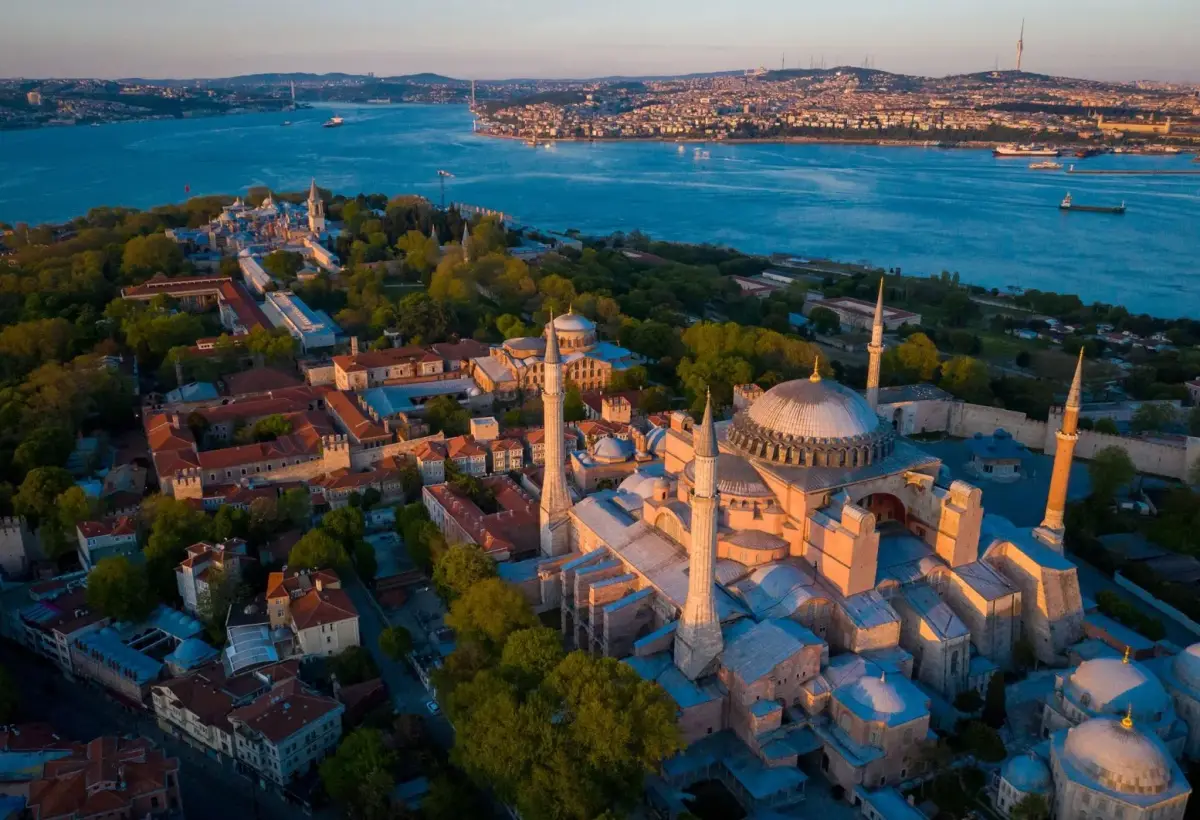 An aerial view of Hagia Sophia and nearby rooftops in Istanbul, with the Bosphorus behind the historic peninsula.