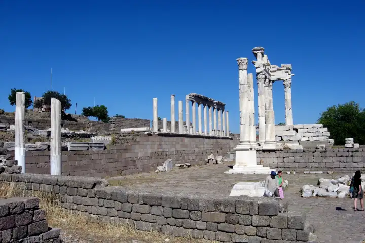 Standing columns and a broken pediment of the Pergamon temple terrace stand out against a deep blue sky.
