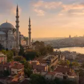 Suleymaniye Mosque above the Golden Horn and historic Istanbul rooftops at sunrise